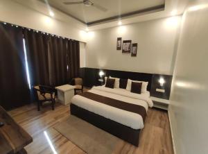 a bedroom with a large bed in a room at Surwel Hotel and Resort in Mussoorie