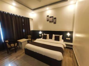 a hotel room with a large bed in a room at Surwel Hotel and Resort in Mussoorie