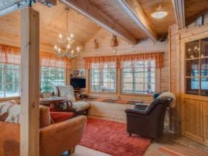 a living room filled with furniture and a chandelier at Holiday Home Ahonranta by Interhome in Juntusranta