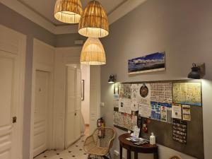 a room with two chandeliers and a bulletin board at Casa Consell Bailen, Guest House in Barcelona