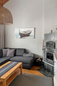 a living room with a couch and a stove at Holiday Home Noukatti by Interhome in Lahdenperä