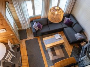 an overhead view of a living room with a black couch at Holiday Home Noukatti by Interhome in Lahdenperä +16 photos