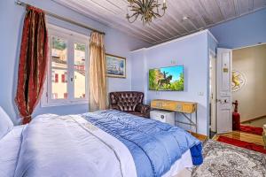 a bedroom with a bed and a chair and a window at Theodoros Kolokotronis in Nafplio