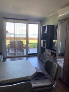 a living room with a couch and a table and a television at Balatonra néző, gyerekbarát. in Fonyód