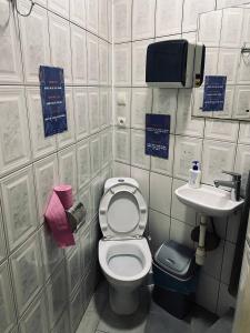 a small bathroom with a toilet and a sink at New York Hostel in Lviv