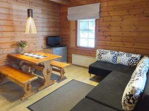 a living room with a table and a couch at Holiday Home Aili by Interhome in Arrakoski
