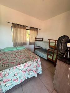 a bedroom with two beds and a window at Rancho Bela Vista in Alexânia