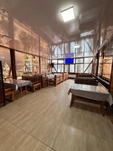 a large room with several beds and windows at Green Veranda in Nurekata