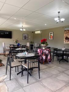 a dining room filled with tables and chairs at The Anne Guest House in Maseru