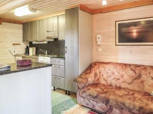 a living room with a couch in a kitchen at Holiday Home Ruska by Interhome in Kyrö +10 photos