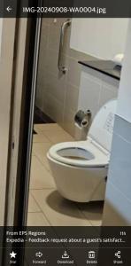 a bathroom with a white toilet in a stall at Platinum Inn Bukitbintang in Kuala Lumpur