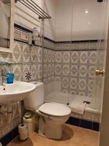 a bathroom with a toilet and a sink and a shower at Casa Consell Bailen, Guest House in Barcelona +58 photos