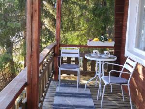 a porch with a table and chairs on it at Holiday Home Hellinki by Interhome in Vaskivesi +17 photos