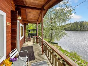 a porch of a house with a view of a lake at Holiday Home Hellinki by Interhome in Vaskivesi
