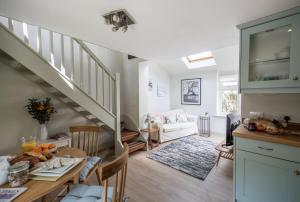 a kitchen and living room with a staircase at The Boathouse in Waldringfield