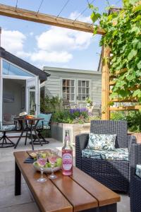 a bottle of wine on a wooden table on a patio at The Boathouse in Waldringfield