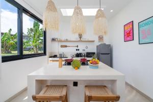 a kitchen with a large white island in a room at Villa Sawahku - 2BR Private Villa with Rooftop & Rice Field View in Canggu