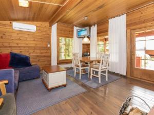 a living room with a couch and a table at Holiday Home Kasilahti by Interhome in Kilvakkala