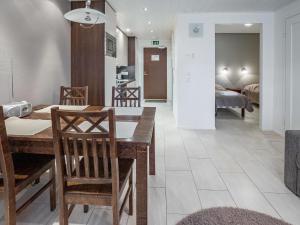 a kitchen and living room with a table and chairs at Holiday Home Yllästar 3 as 616 by Interhome in Äkäslompolo
