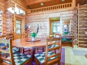 a dining room with a wooden table and chairs at Holiday Home Kivitasku by Interhome in Kallionkieli