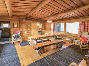 a living room with a wooden table in a cabin at Holiday Home Miilumaja by Interhome in Äkäslompolo