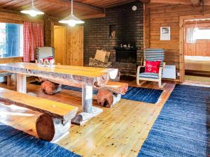 a living room with a wooden table and a fireplace at Holiday Home Miilumaja by Interhome in Äkäslompolo