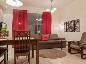 a living room with a couch and a table at Holiday Home Yllästar 3 as 609 by Interhome in Äkäslompolo