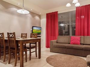 a living room with a table and a couch at Holiday Home Yllästar 3 as 609 by Interhome in Äkäslompolo