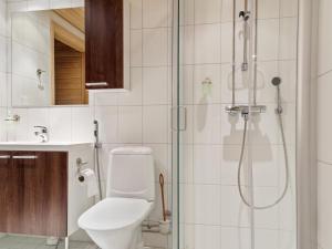 a bathroom with a shower and a toilet and a sink at Holiday Home Yllästar 3 as 609 by Interhome in Äkäslompolo