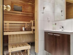 a bathroom with a toilet and a sink at Holiday Home Yllästar 3 as 609 by Interhome in Äkäslompolo +6 photos