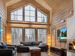 a large living room with couches and a large window at Holiday Home Sopukka by Interhome in Vuokatti