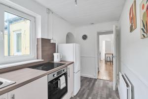 a kitchen with a refrigerator and a sink at Suggitt House in Hartlepool