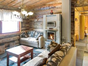 a living room with a couch and a fireplace at Holiday Home Äkäsranta by Interhome in Äkäsjoensuu
