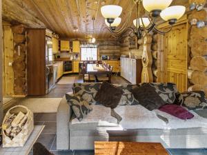a living room with a couch and a kitchen at Holiday Home Äkäsranta by Interhome in Äkäsjoensuu