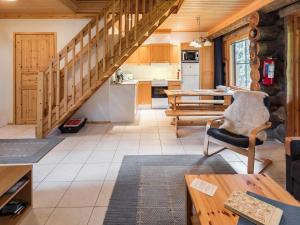 a living room with a staircase and a kitchen at Holiday Home Sapara c10 by Interhome in Äkäslompolo