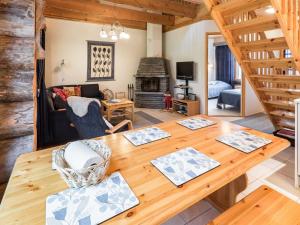 a dining room and living room with a wooden table at Holiday Home Sapara c10 by Interhome in Äkäslompolo +11 photos