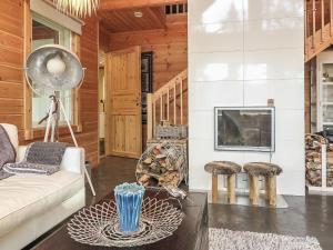 a living room with a couch and a tv at Holiday Home Homma by Interhome in Kyrö