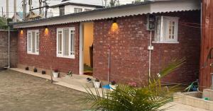 a red brick house with plants in front of it at Engineers Retreat in Srinagar