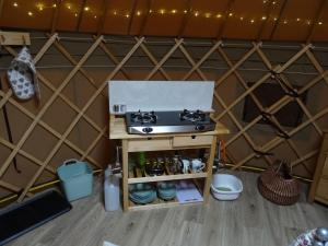 a stove on a table in a yurt at Willey Lane Farm in Lingen