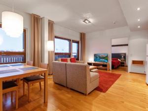 a living room with a couch and a table at Holiday Home Ski chalets 6405 by Interhome in Ylläsjärvi
