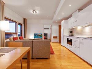 a kitchen and living room with a couch and a table at Holiday Home Ski chalets 6405 by Interhome in Ylläsjärvi