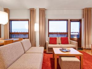 a living room with two couches and a table at Holiday Home Ski chalets 6405 by Interhome in Ylläsjärvi