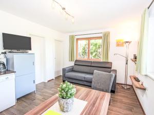 a living room with a couch and a tv at Apartment Barbara-1 by Interhome in Fügen