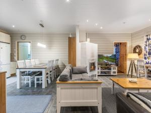 a kitchen and living room with a couch and a table at Holiday Home Tuulenpuuska by Interhome in Äkäslompolo