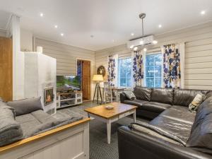 a living room with a couch and a table at Holiday Home Tuulenpuuska by Interhome in Äkäslompolo