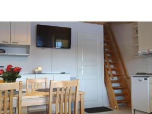a kitchen with a dining room table and a staircase at Holiday Home Levi star 1009 by Interhome in Levi