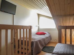 a small bedroom with a bed and a window at Holiday Home Levi star 1009 by Interhome in Levi +5 photos