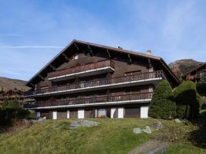 a building with balconies on top of a hill at Studio Diure 0113 by Interhome in Verbier