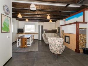 a living room with chairs and a table and a kitchen at Holiday Home Halmesaari by Interhome in Kerkonjoensuu