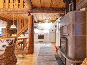 a kitchen and dining room with a large fireplace at Holiday Home Tunturitorppa by Interhome in Äkäslompolo
